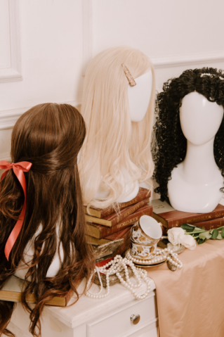 Woman selecting hair color samples in a salon, showcasing shades of brown and blonde.