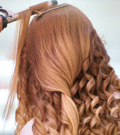 Close-up of an elegant bridal hairstyle featuring delicate white flowers, perfect for a wedding day.